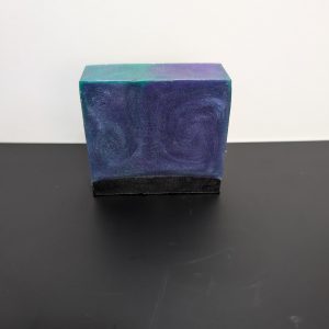 Square soap bar with a mix of Green, Purple (swirled together) and Black.