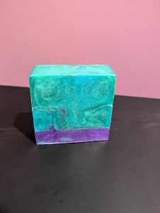 Square soap bar with a mix of Green, Blue (swirled together) and Purple.