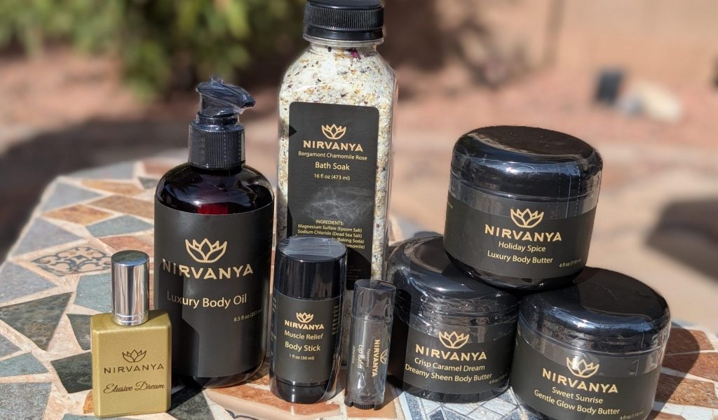 Image of Nirvanya Products. Multiple body butters, bath soak, body oil, perfume, muscle stick, chap stick.